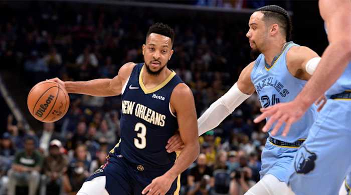 New Orleans Pelicans guard CJ McCollum (3) drives on Memphis Grizzlies forward Dillon Brooks (24) during the first half of an NBA basketball game Saturday, April 9, 2022, in Memphis, Tenn.